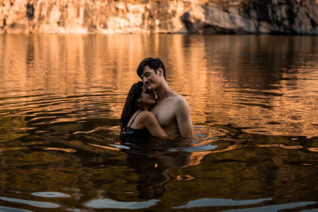 Couple swimming in a lake during their elopement