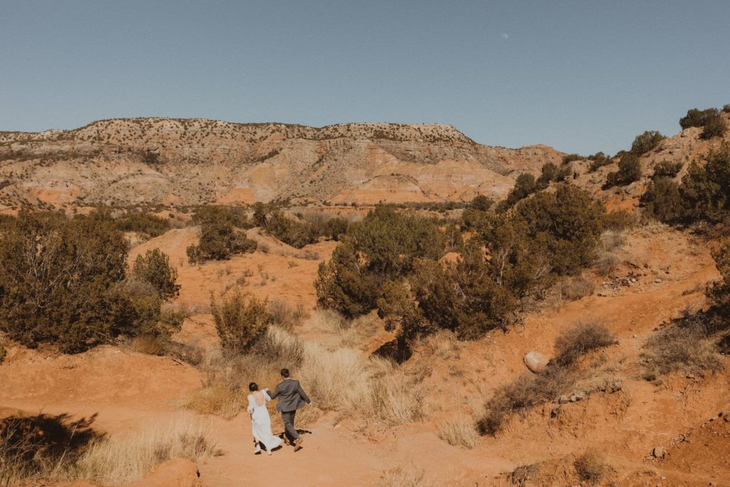 Couple hiking around Palo Duro Canyon on their elopement day.