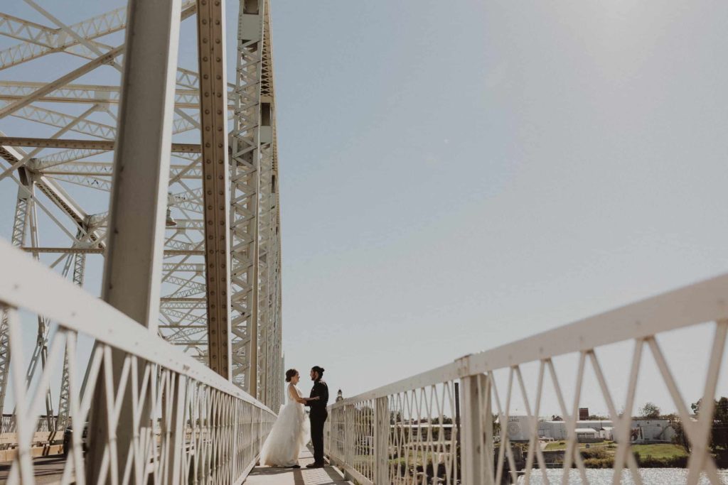Couple crossing the roy inks bridge during their Llano River Elopement