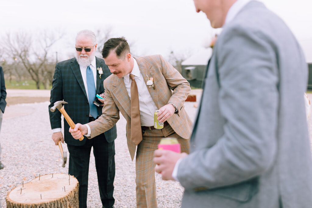 groomsmen play wedding lawn games