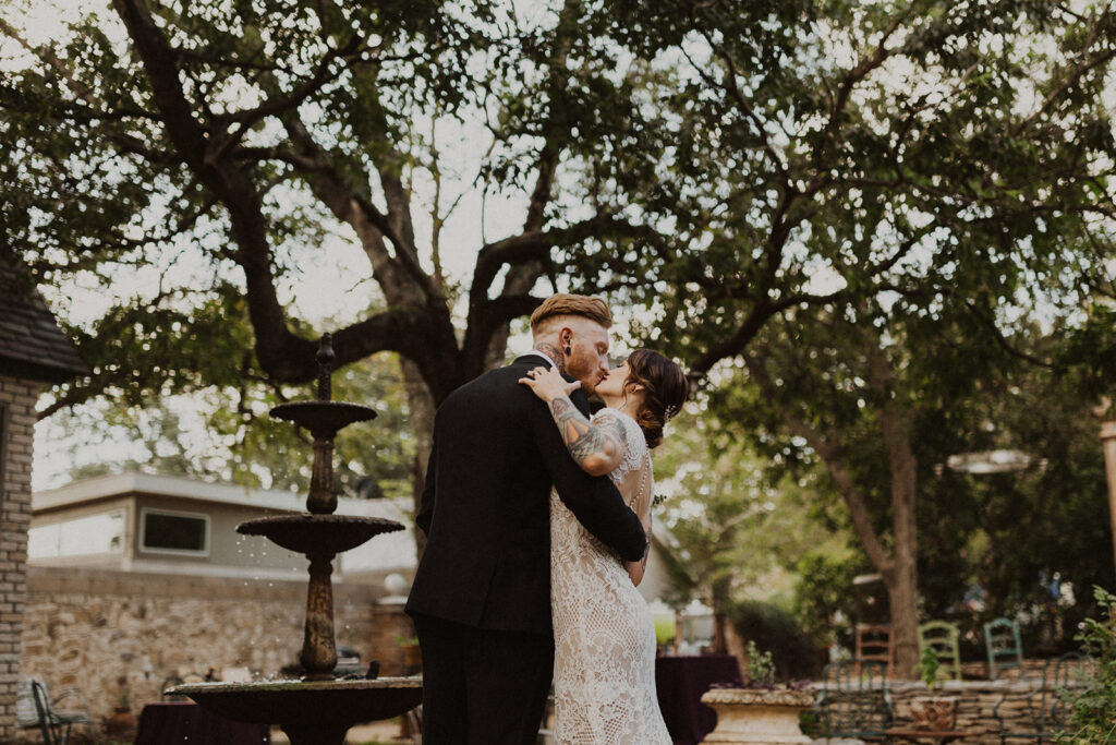 couple kisses at outdoor wedding 