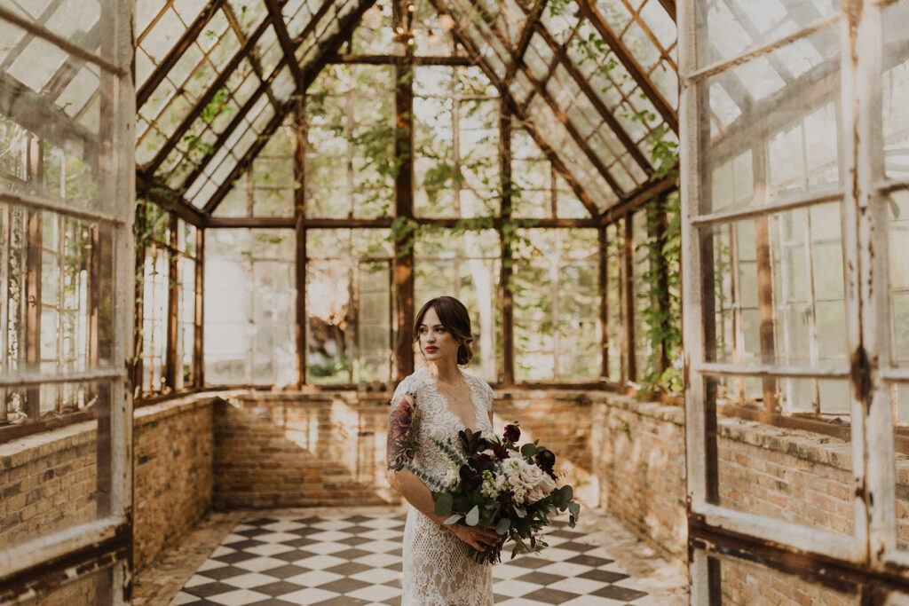 bride stands in Sekrit Theater vintage greenhouse 