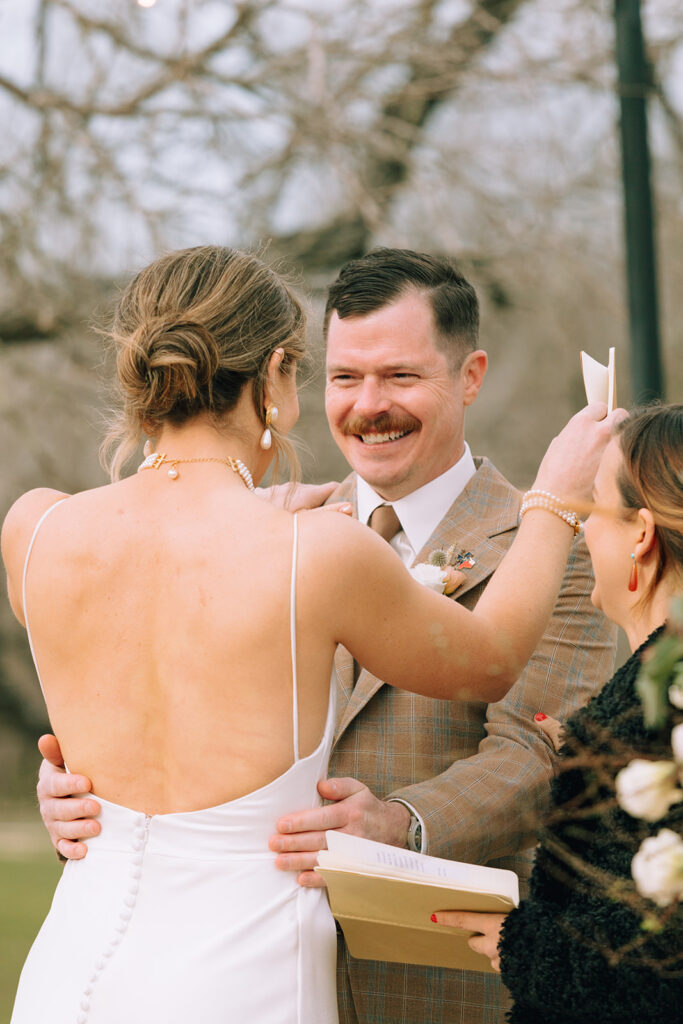 couple embraces during outdoor wedding ceremony