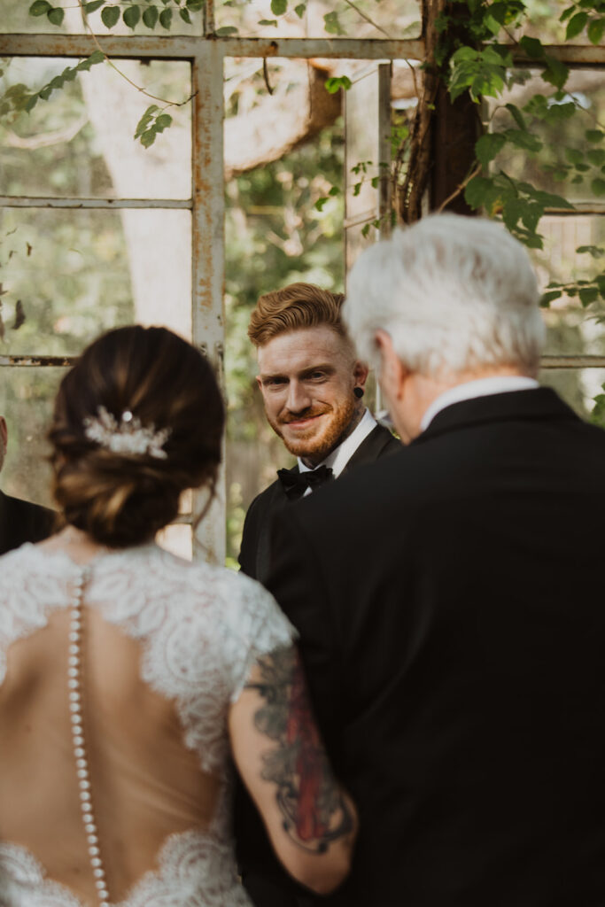 groom sees bride at vintage greenhouse wedding