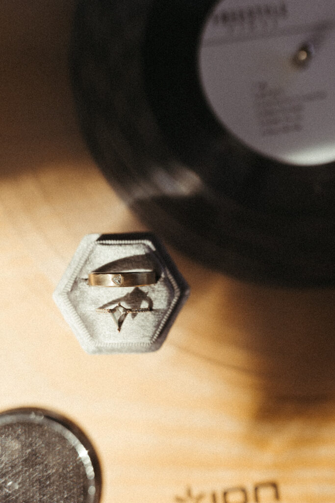 wedding bands beside vinyl record on record player