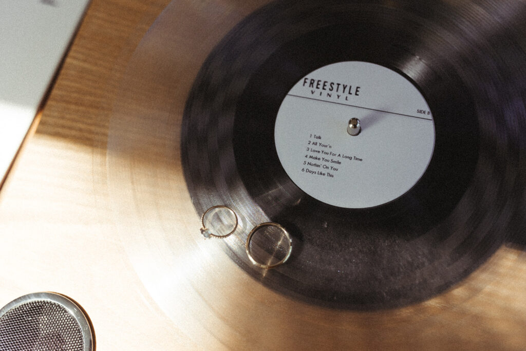 wedding rings next to vinyl record