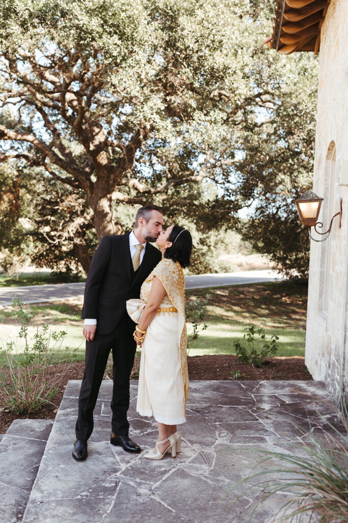 couple kisses in front of Garey House wedding venue