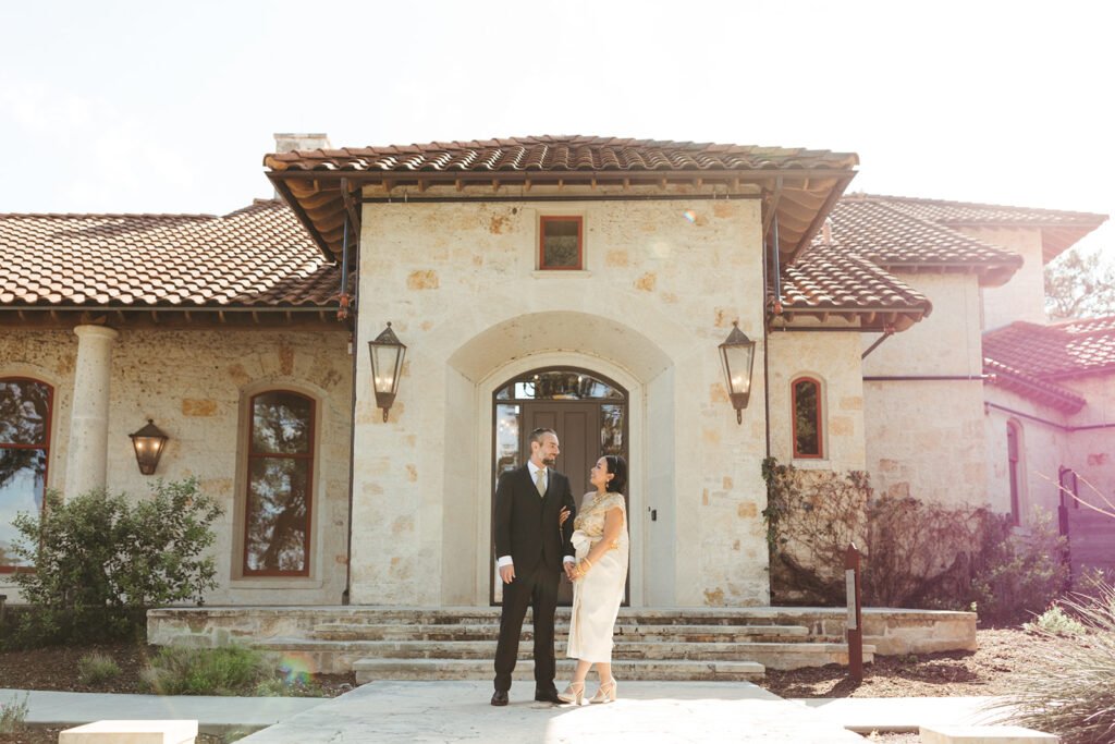 couple stands in front of Garey House wedding venue