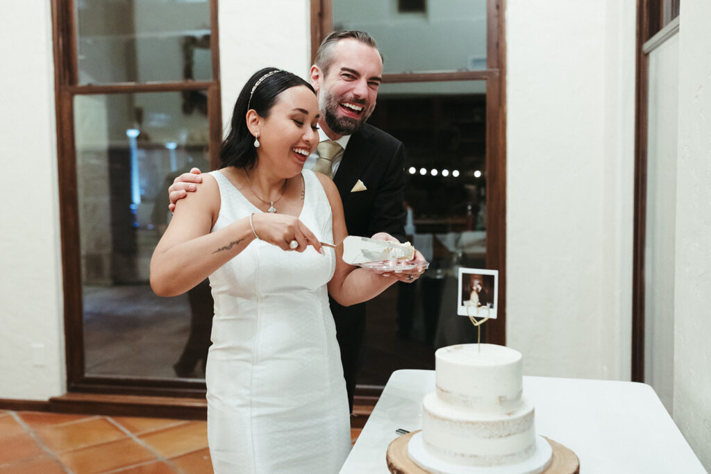 couple cuts the cake at wedding reception 