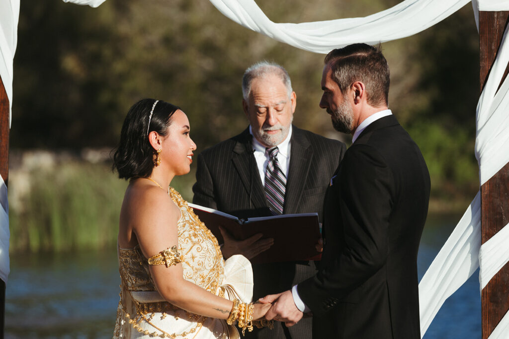 couple exchanges vows at lakeside wedding venue