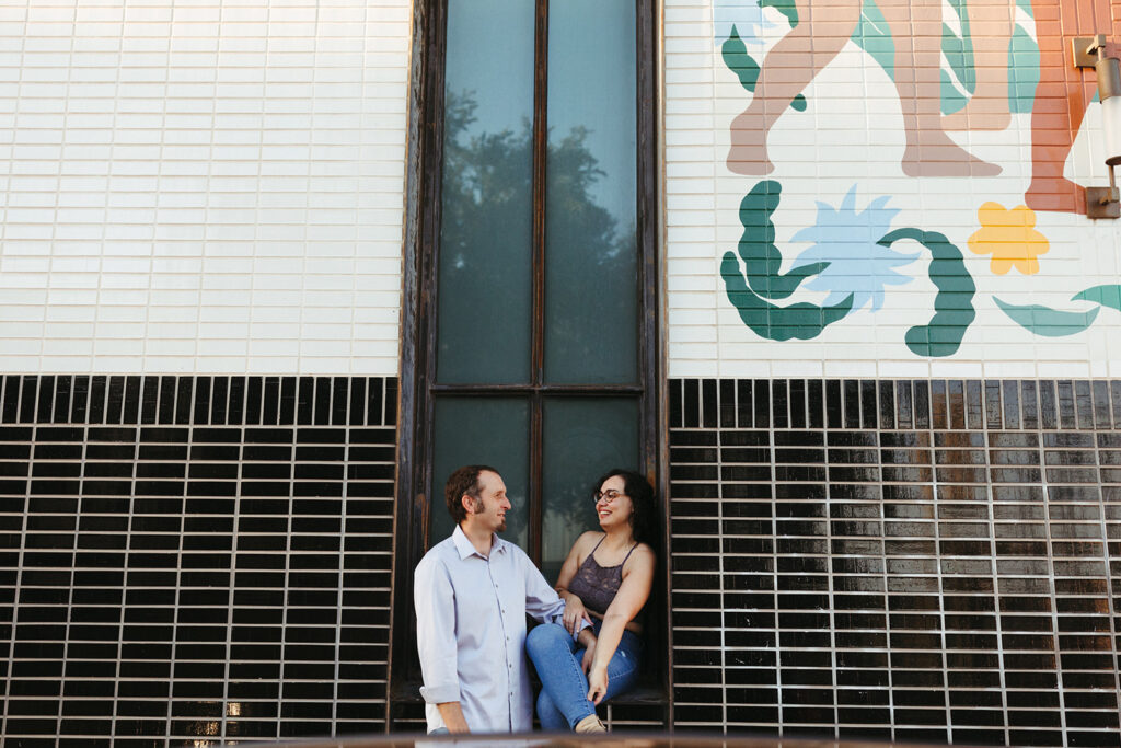 Austin engagement photographer captures couple sitting on window sill