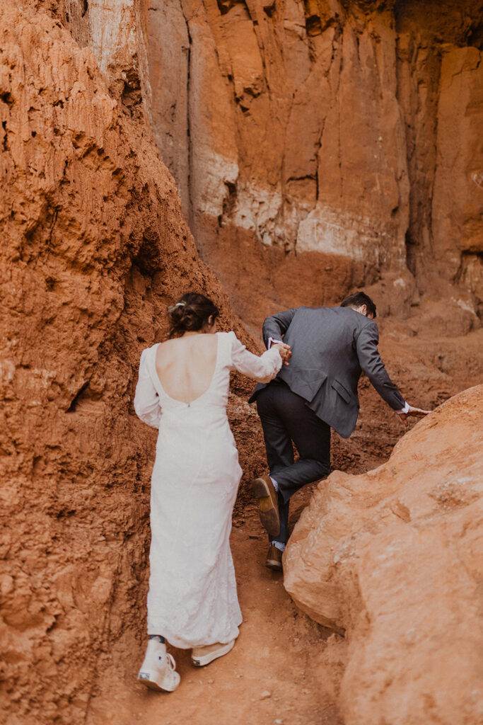 couple climbs red rocks during Texas elopement