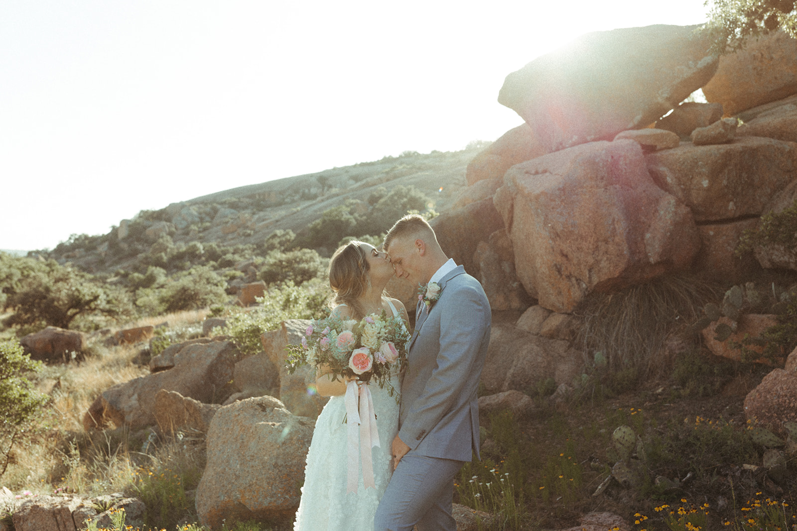 couple kisses at sunset enchanted rock elopement