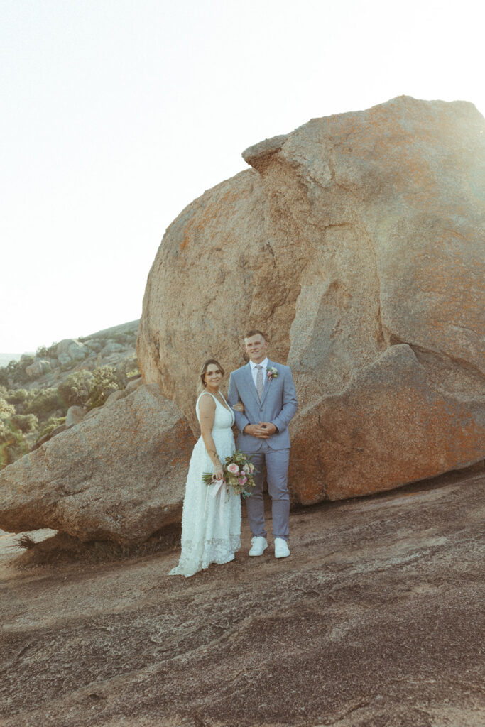couple embraces at enchanted rock sunset elopement