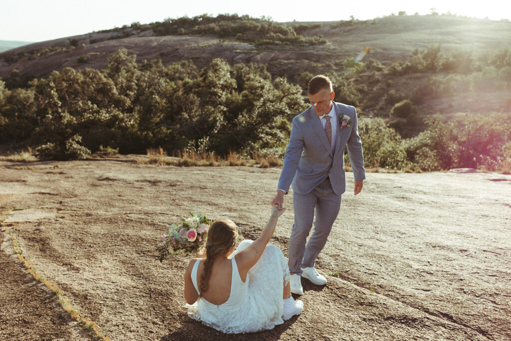 couple holds hands at enchanted rock sunset elopement