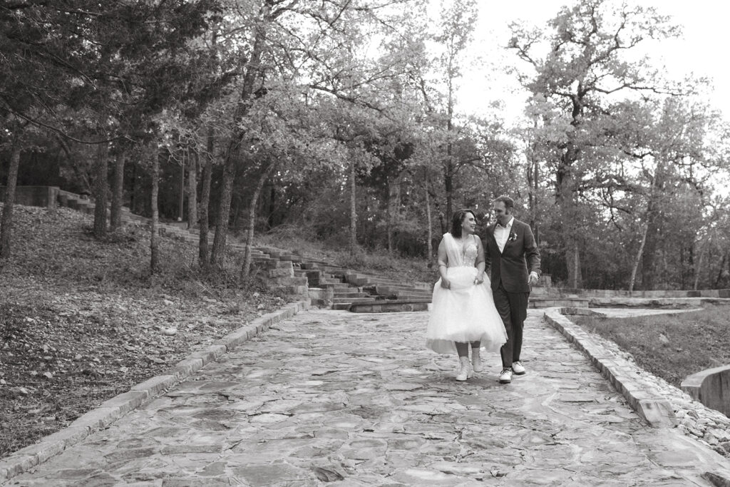 couple walks along path at texas Shiraz Garden wedding venue