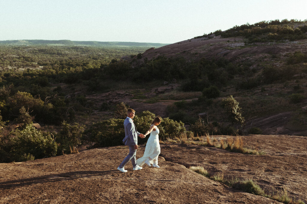 couple walks along mountain at sunset elopement 