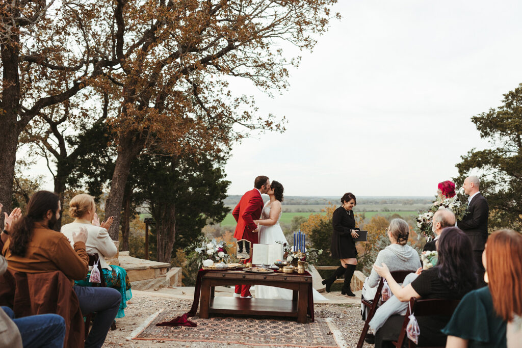 couple kisses during ceremony at Shiraz Garden in Texas