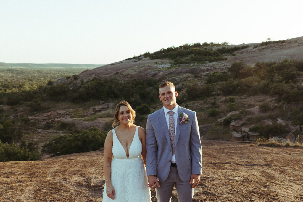 couple holds hands At Texas Hill Country wedding