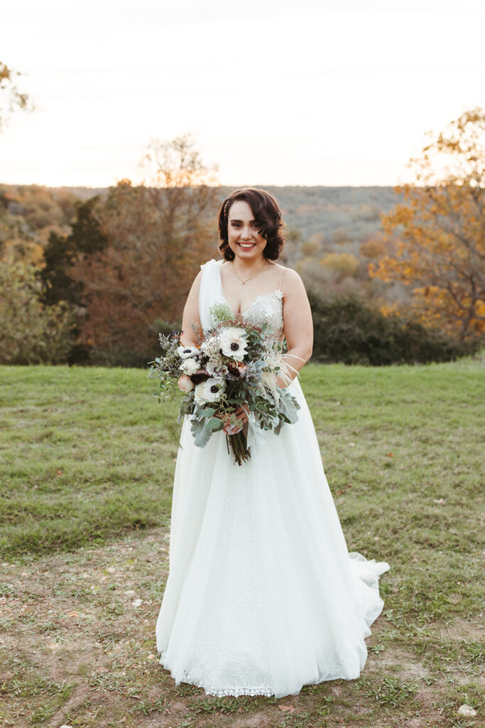 bride holds wildflower wedding bouquet
