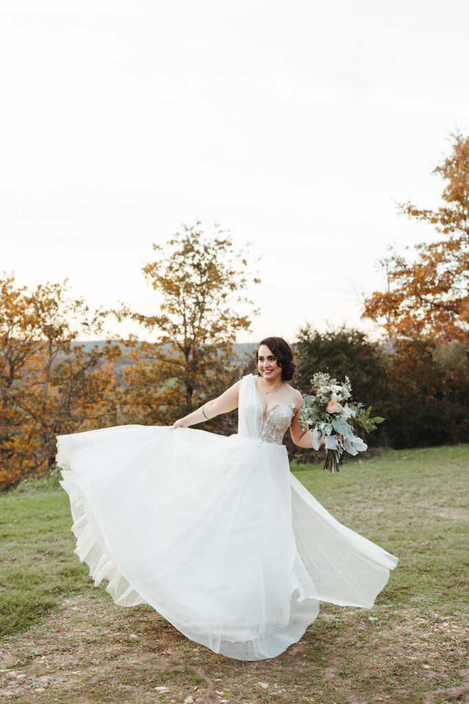 bride twirls in wedding dress at sunset 