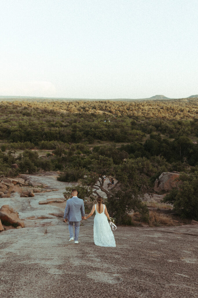 couple walks holding hands at Texas Hill Country wedding elopement