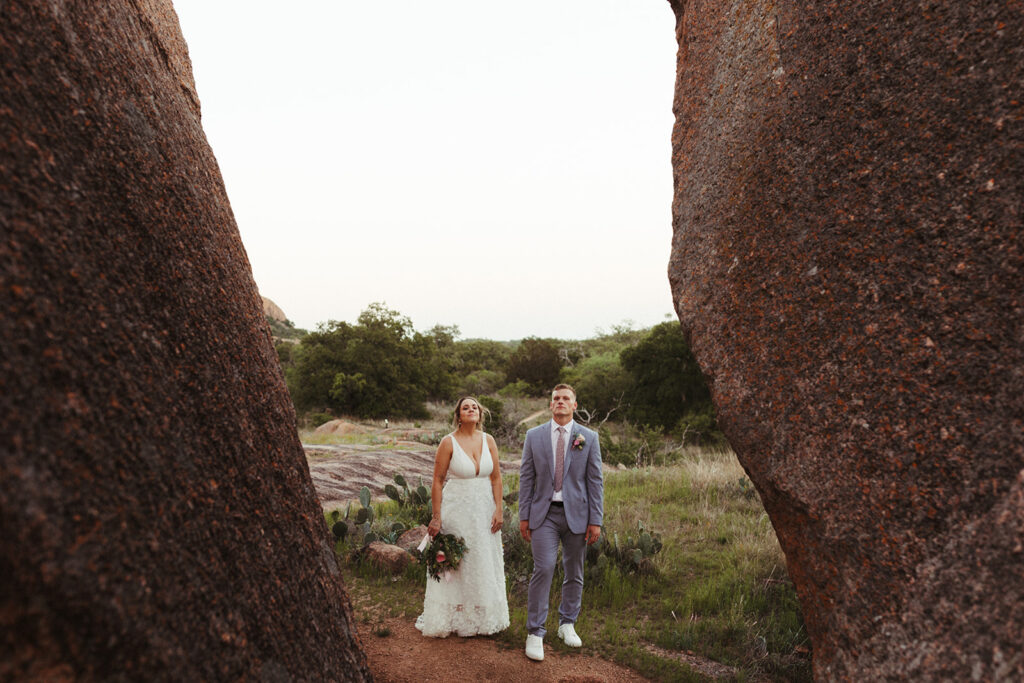 couple looks up at enchanted rock sunset elopement