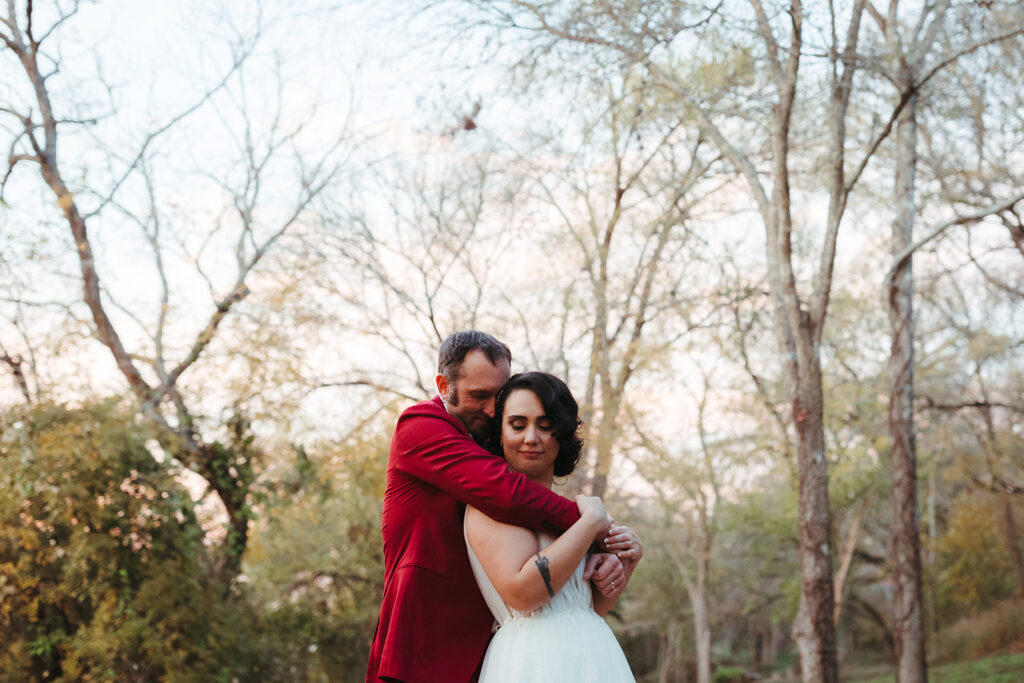 couple embraces at outdoor wedding venue in Texas