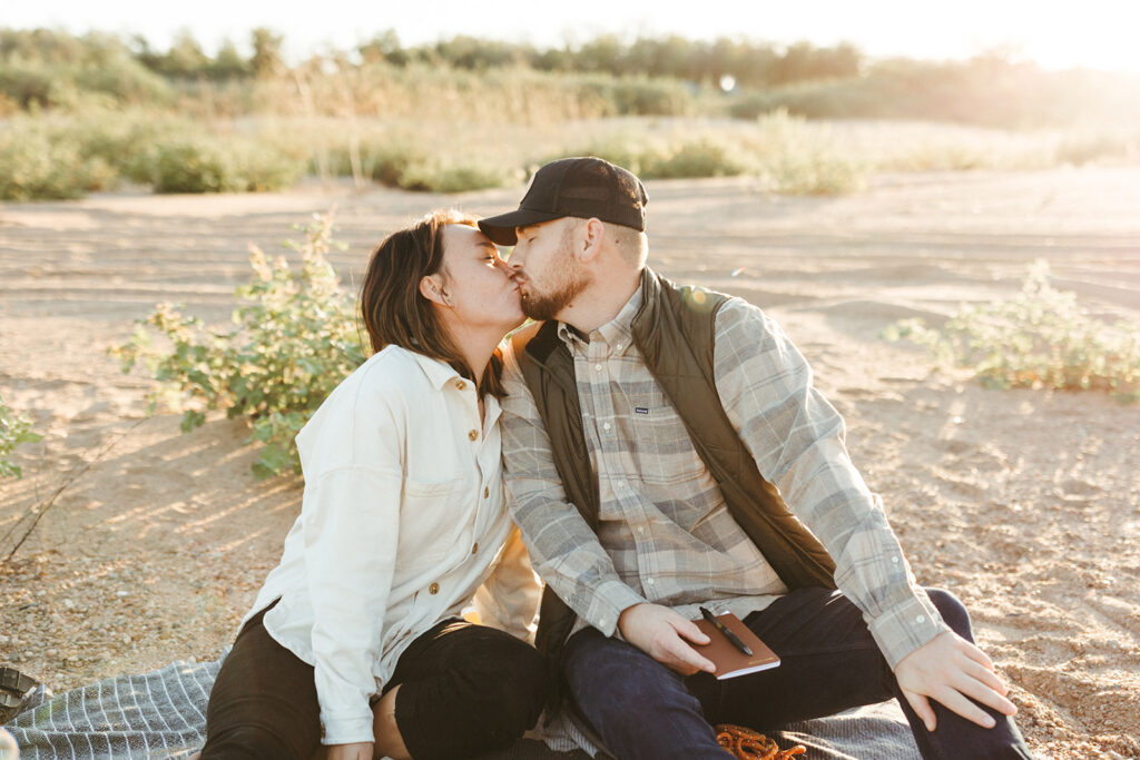 couple kisses during lakeside elopement 