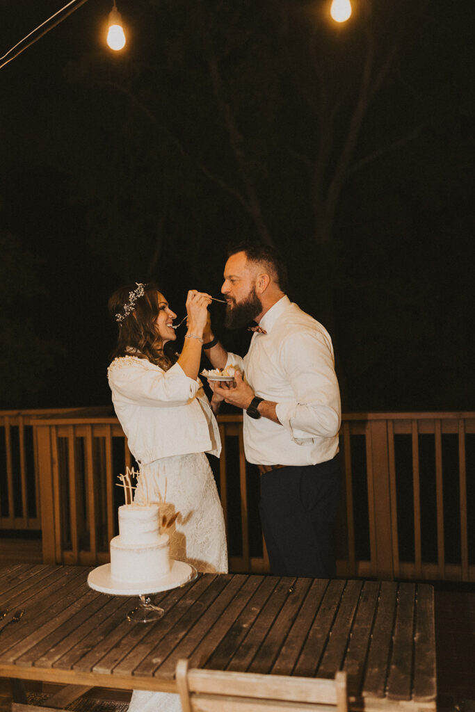 couple eats cake during elopement reception
