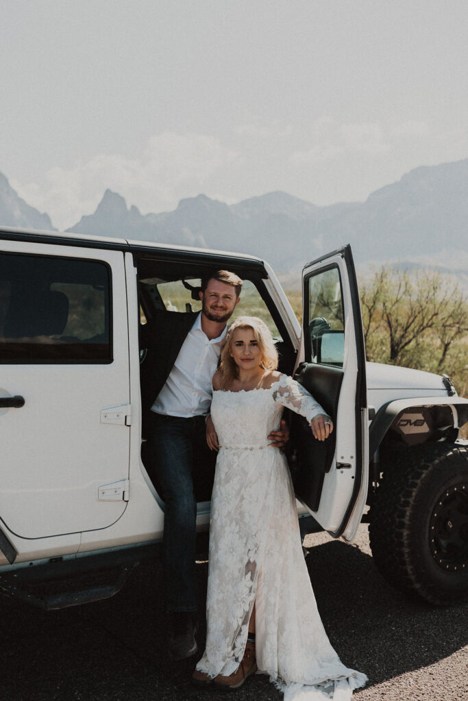 couple stands beside Jeep during adventure elopement