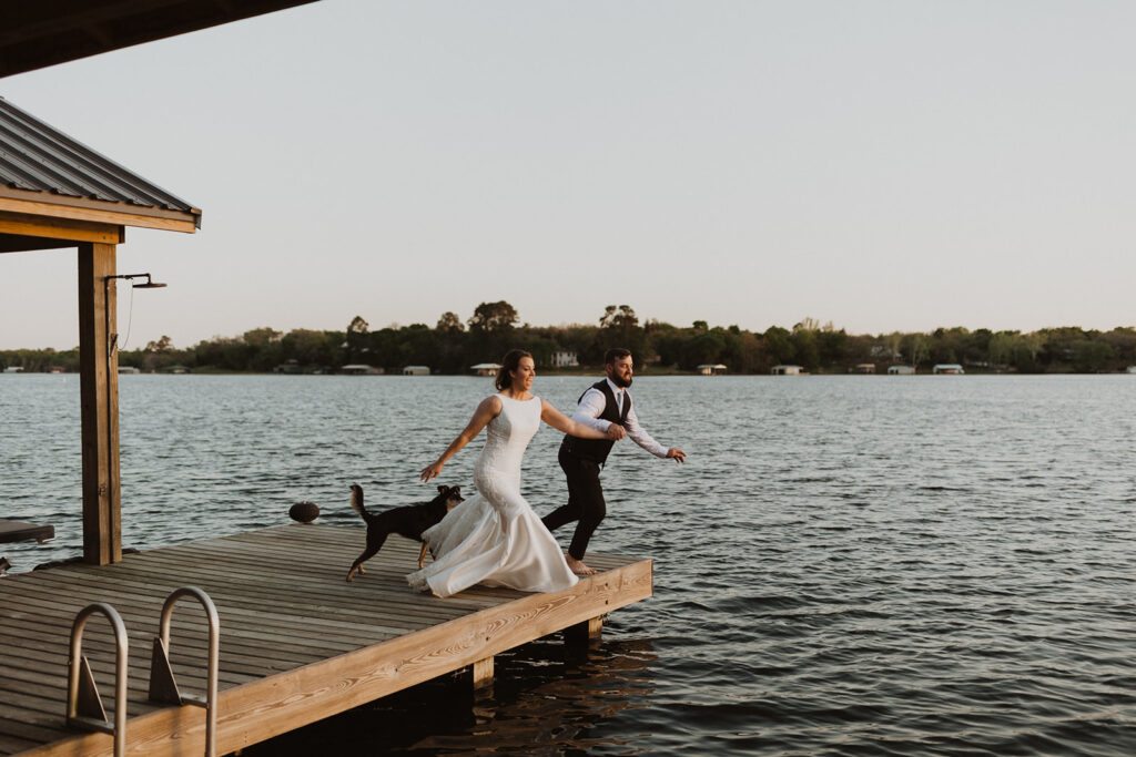 couple jumps into lake in wedding clothes