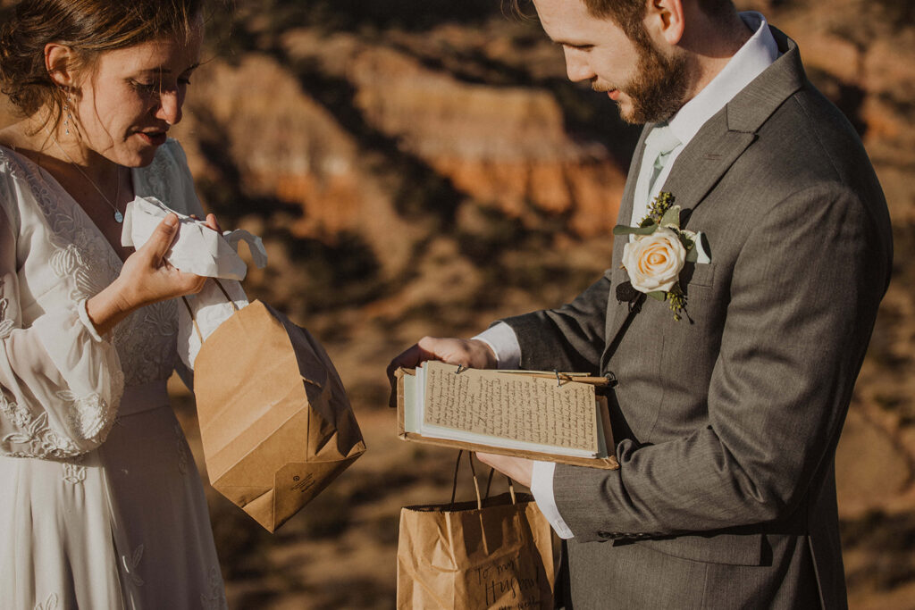 couple exchanges gifts at sunrise elopement 