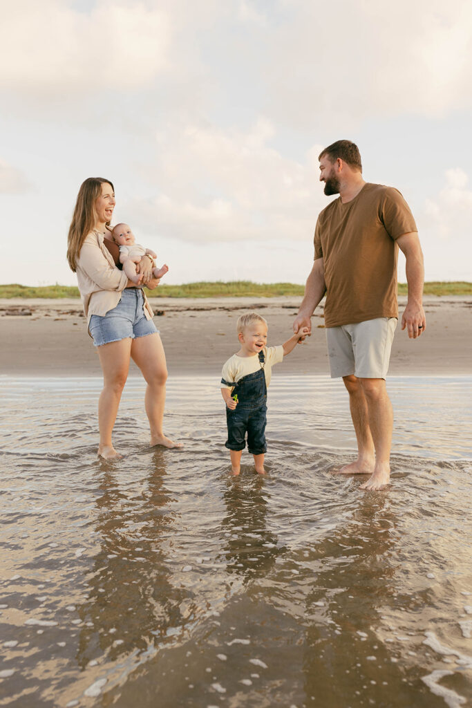 Family playing in the water on Galveston Beach Texas