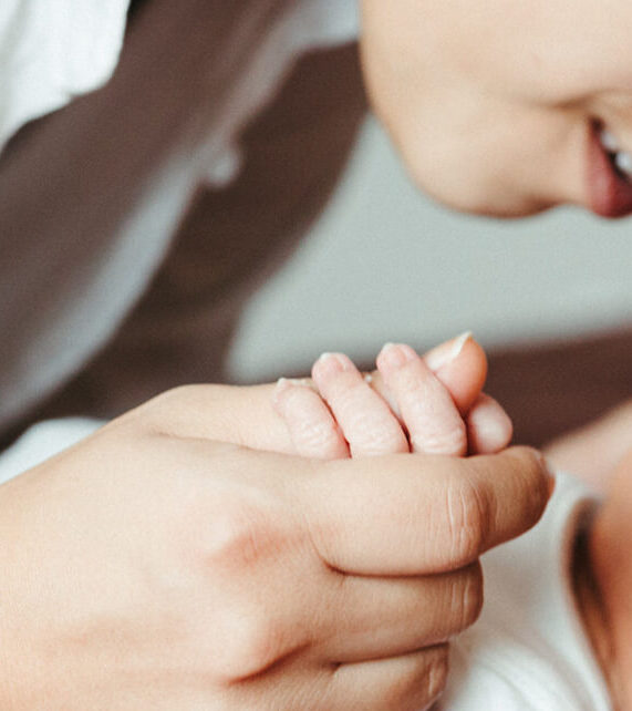 Woodlands Newborn Photographer Mother holding baby's hand